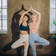 parnter yoga demo with two women doing tree pose together